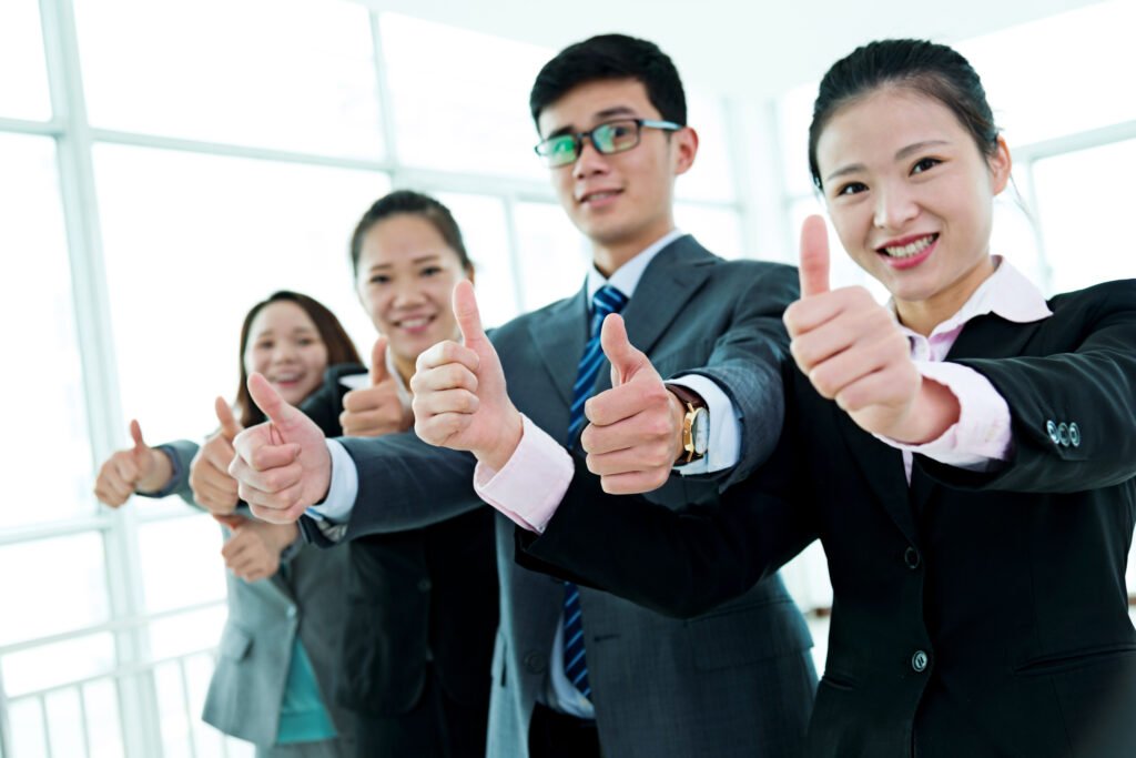 Business Team Gesturing Thumbs Up